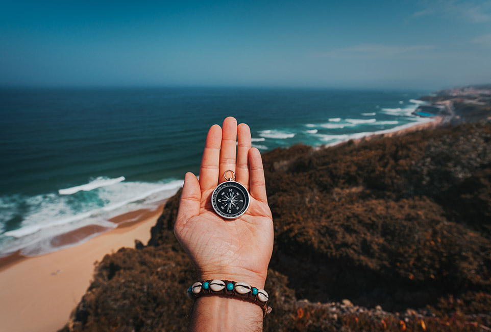 pov-man-hand-with-compass-symbolling-adventure-see-A23HY3U