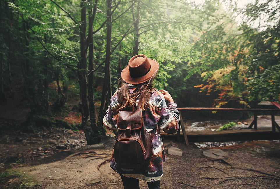 stylish-hipster-girl-in-hat-traveling-in-mountains-3WHL7TG
