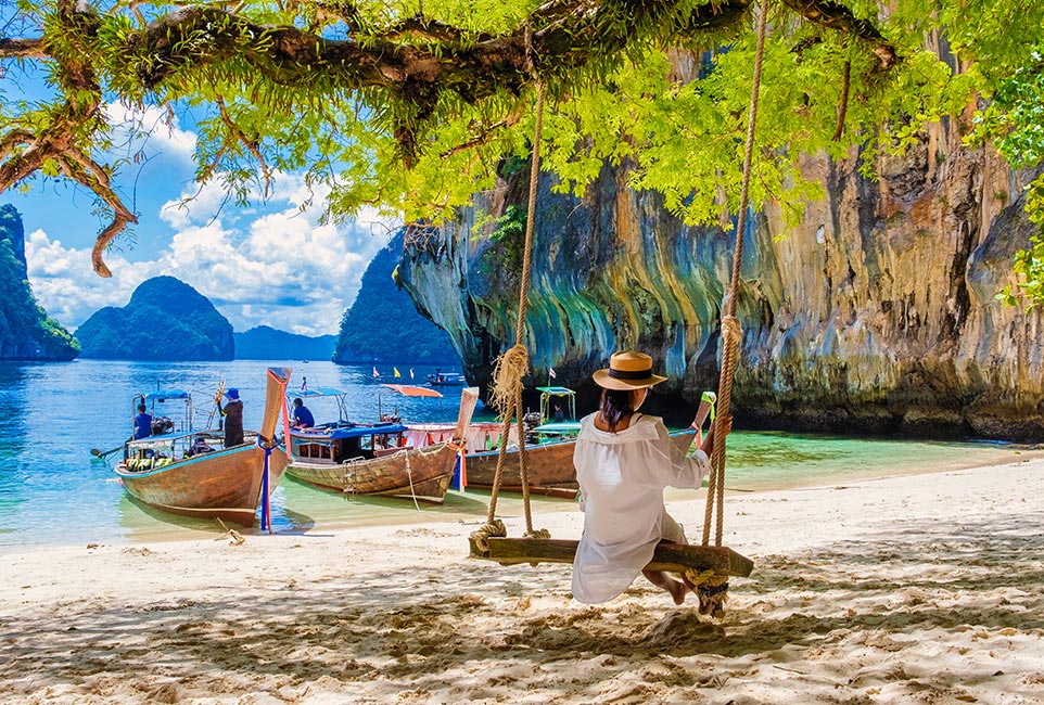women-on-a-swing-at-the-tropical-lagoon-of-koh-loa-NJXK9TM